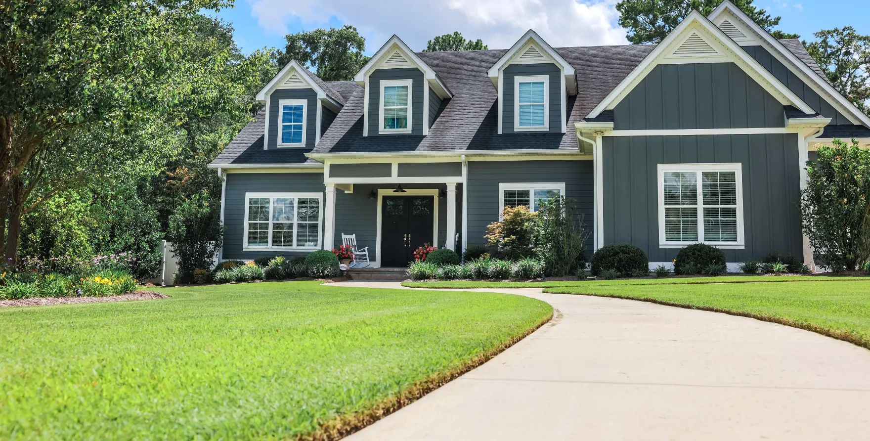 Residential concrete walkway and front entry path leading to the home’s porch