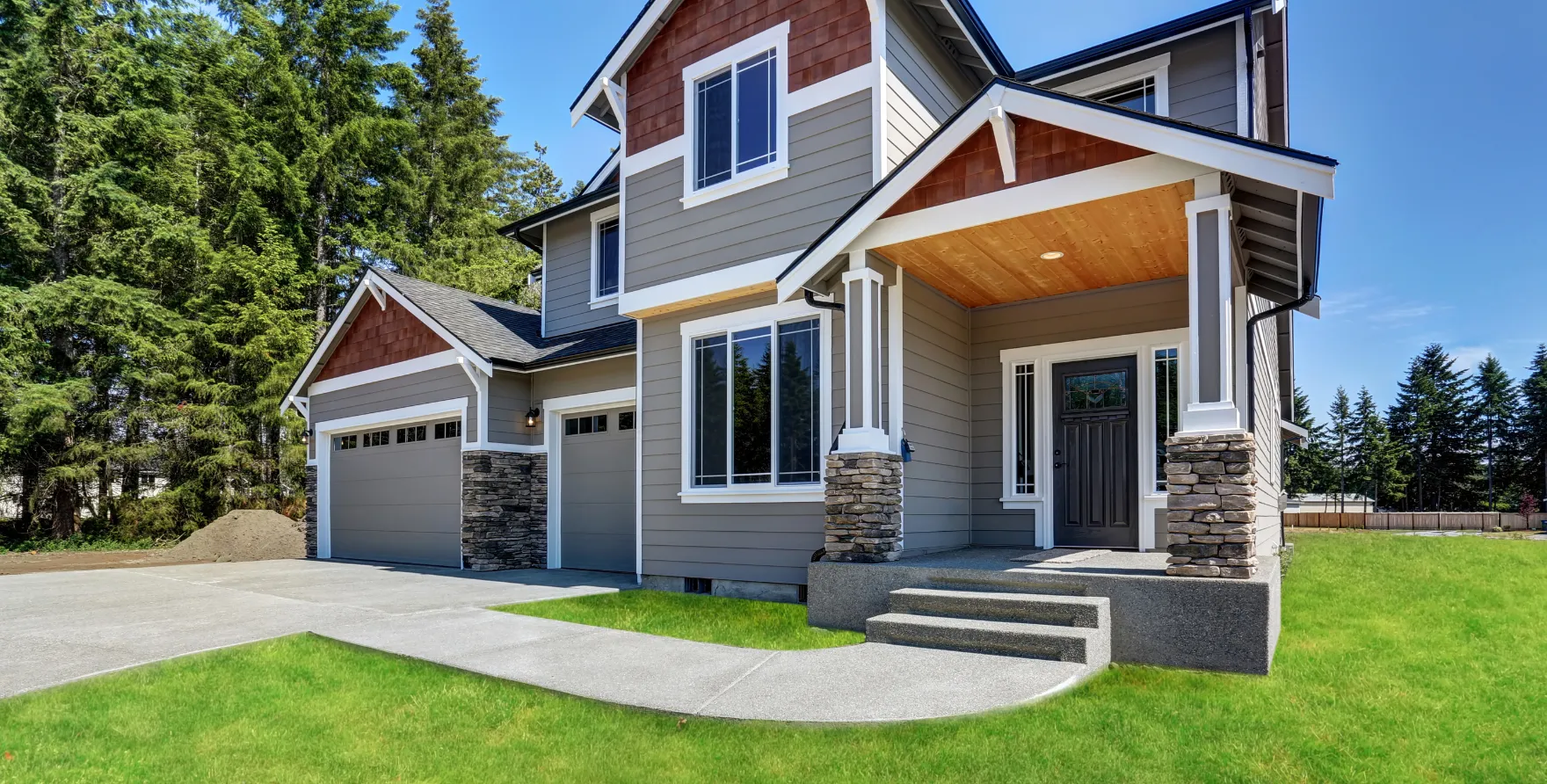 Newly installed residential concrete porch and curved walkway connecting the driveway to the home entrance